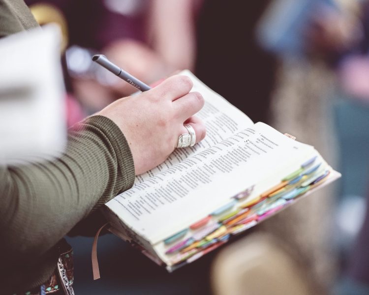 Woman making notes in the Bible
